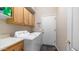 Functional laundry room featuring cabinetry, modern appliances, and tile flooring at 1620 W Nighthawk Way, Phoenix, AZ 85045