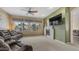 Spacious living room with a fireplace, ceiling fan, and large windows showcasing desert landscaping at 1620 W Nighthawk Way, Phoenix, AZ 85045