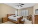 Comfortable main bedroom with a wood bedframe, plantation shutters, and cozy seating area at 1620 W Nighthawk Way, Phoenix, AZ 85045