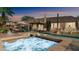 Exterior view of the in-ground pool and spa with lounge chairs and umbrellas on the pool deck at 1620 W Nighthawk Way, Phoenix, AZ 85045