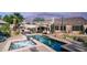 Inviting backyard with pool, spa, desert landscaping, covered patio, and outdoor seating at sunset at 1620 W Nighthawk Way, Phoenix, AZ 85045