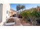 A peaceful side yard featuring a hot tub, garden, and paved pathway at 1620 W Nighthawk Way, Phoenix, AZ 85045