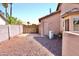 Backyard with gravel, block fence, and access door at 1624 E Marigold St, Casa Grande, AZ 85122