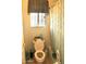 Bathroom features a toilet, shower with curtain, and a window with blinds at 1624 E Marigold St, Casa Grande, AZ 85122