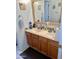 Bathroom features a double sink vanity with oak cabinets, a large mirror, and decorative tile accents at 1624 E Marigold St, Casa Grande, AZ 85122