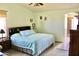 Bedroom with hardwood flooring, featuring traditional furnishings and decor at 1624 E Marigold St, Casa Grande, AZ 85122
