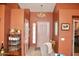 Elegant foyer featuring neutral walls, tile flooring, chandelier lighting, and a beautiful front door at 1624 E Marigold St, Casa Grande, AZ 85122