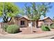 Charming single-story home featuring a well-maintained yard with desert landscaping and mature trees at 1624 E Marigold St, Casa Grande, AZ 85122