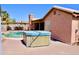 Backyard hot tub and outdoor patio with pool in the background, perfect for outdoor entertaining at 1624 E Marigold St, Casa Grande, AZ 85122