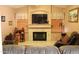Inviting living room showcasing a fireplace, mounted television, and comfortable seating area at 1624 E Marigold St, Casa Grande, AZ 85122