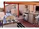 Outdoor kitchen featuring a built in grill, bar seating, and mini fridge with tiled flooring at 1624 E Marigold St, Casa Grande, AZ 85122
