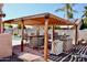Covered outdoor kitchen area with bar, grill, and brick flooring perfect for entertaining at 1624 E Marigold St, Casa Grande, AZ 85122