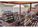 Outdoor kitchen with bar seating, stainless steel BBQ grill under wood pergola and tiled flooring at 1624 E Marigold St, Casa Grande, AZ 85122