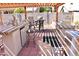 Outdoor kitchen featuring a built in grill, bar seating, and mini fridge with tiled flooring at 1624 E Marigold St, Casa Grande, AZ 85122