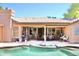 Covered patio off the pool, featuring tile flooring, ceiling fan, and outdoor furniture at 1624 E Marigold St, Casa Grande, AZ 85122