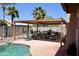 Backyard pergola with an outdoor dining area next to the pool, perfect for entertaining at 1624 E Marigold St, Casa Grande, AZ 85122
