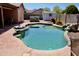 Backyard pool featuring rock detail, hot tub, and patio area, perfect for outdoor living and entertaining at 1624 E Marigold St, Casa Grande, AZ 85122