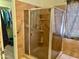 Shower stall featuring grab bars and built in shelves, connecting to closet at 1624 E Marigold St, Casa Grande, AZ 85122