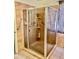 Shower with glass door and grab bars, featuring tile surround and built in shelves at 1624 E Marigold St, Casa Grande, AZ 85122