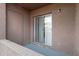 Enclosed balcony featuring textured stucco walls and sliding glass doors for natural light at 16602 N 25Th St # 112, Phoenix, AZ 85032