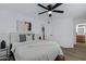 Bright bedroom featuring hardwood floors, ceiling fan, and a modern accent wall with art at 16602 N 25Th St # 112, Phoenix, AZ 85032