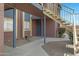 Condominium exterior with a landing, gravel, green plants, concrete walkway and staircase to the 2nd level at 16602 N 25Th St # 112, Phoenix, AZ 85032