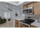 Open kitchen leading to a living area featuring modern appliances and hardwood flooring at 16602 N 25Th St # 112, Phoenix, AZ 85032