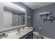 Inviting bathroom featuring a well-lit mirror, floating shelves, and classic blue and white decor at 16801 N 94Th St # 1010, Scottsdale, AZ 85260