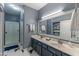 A full bathroom with double sinks, a walk-in shower and a large mirror at 16801 N 94Th St # 1010, Scottsdale, AZ 85260