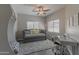 Charming bedroom with a gray daybed, a plush rug, a work desk, and windows with views of the outdoors at 16801 N 94Th St # 1010, Scottsdale, AZ 85260