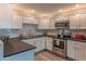 Modern kitchen featuring white cabinets, stainless steel appliances, and granite countertops at 16801 N 94Th St # 1010, Scottsdale, AZ 85260