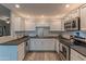 Bright kitchen features modern appliances, white cabinets, and a subway tile backsplash at 16801 N 94Th St # 1010, Scottsdale, AZ 85260