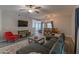 A well-lit living room boasts a ceiling fan, television, rug and furniture for relaxing and entertaining at 16801 N 94Th St # 1010, Scottsdale, AZ 85260