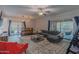 This living room features a ceiling fan, large sectional sofa, and sliding door to a balcony at 16801 N 94Th St # 1010, Scottsdale, AZ 85260