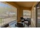 Relaxing outdoor patio with wicker furniture, roll-down shades, and tranquil desert views at 16801 N 94Th St # 1010, Scottsdale, AZ 85260