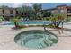 Luxurious community pool and spa area with lounge chairs, palm trees, and meticulously landscaped surroundings at 16801 N 94Th St # 1010, Scottsdale, AZ 85260