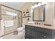 Bathroom features a granite-topped vanity and tiled walk-in shower with a rainfall shower head and glass doors at 16823 S 8Th St, Phoenix, AZ 85048