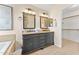 Stylish bathroom featuring a double vanity with granite countertops and a walk-in closet at 16823 S 8Th St, Phoenix, AZ 85048