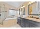 Elegant bathroom with a double vanity, granite countertops, and a glass-enclosed shower at 16823 S 8Th St, Phoenix, AZ 85048