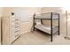 ' bedroom features a black metal bunk bed next to a matching wooden dresser with drawers at 16823 S 8Th St, Phoenix, AZ 85048