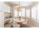 Charming breakfast nook with a modern light fixture, white shutters, and a round table at 16823 S 8Th St, Phoenix, AZ 85048