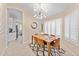 Dining area with modern chandelier, plantation shutters, a table set for six at 16823 S 8Th St, Phoenix, AZ 85048