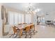 An open dining area with a modern light fixture, seating for six, and tile flooring at 16823 S 8Th St, Phoenix, AZ 85048