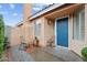 Charming front porch featuring a blue door, two chairs, and a small table at 16823 S 8Th St, Phoenix, AZ 85048