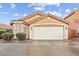 A front view of a one-story house with a terra cotta roof and a two-car garage at 16823 S 8Th St, Phoenix, AZ 85048