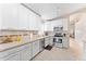 Bright kitchen featuring white cabinets, stainless steel appliances, and tile backsplash at 16823 S 8Th St, Phoenix, AZ 85048