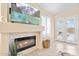 Cozy living room showing a fireplace, tile surround, TV, and view of the pool at 16823 S 8Th St, Phoenix, AZ 85048