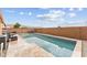 Sparkling in-ground pool surrounded by brick wall, with a beautiful view of the desert mountains in the distance at 16823 S 8Th St, Phoenix, AZ 85048