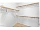 Bright walk-in closet features ample storage with wooden rods and shelves, perfect for organization and accessibility at 16823 S 8Th St, Phoenix, AZ 85048