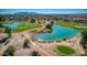 Expansive aerial view of the serene pond and lush green golf course, a nature-filled oasis at 172 S Agua Fria Ln, Casa Grande, AZ 85194